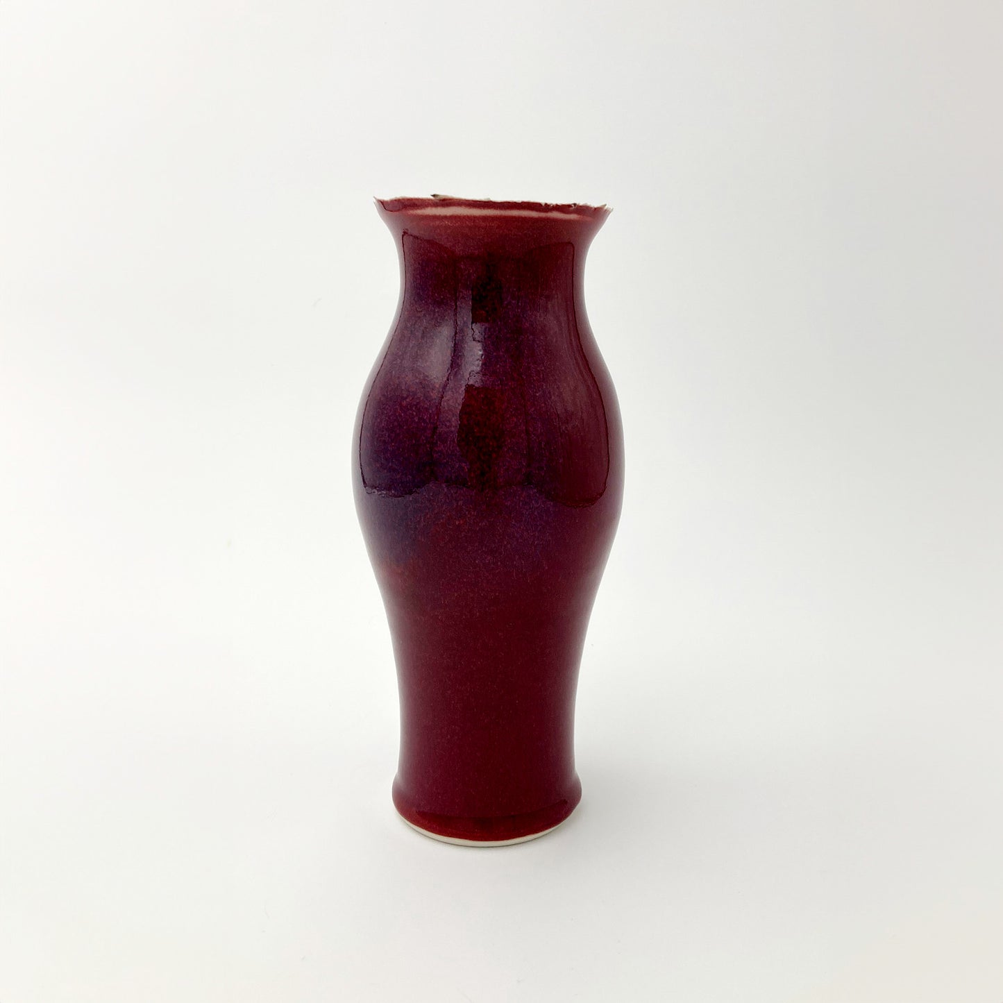Red ceramic vase unique rim on a white background