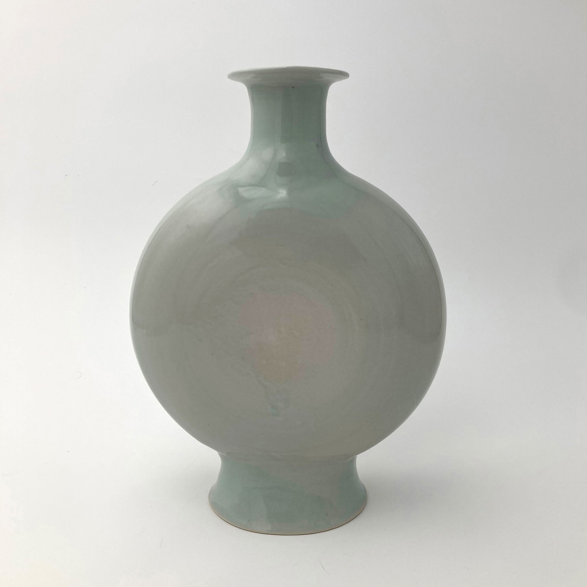 Green ceramic canteen vase on a white background