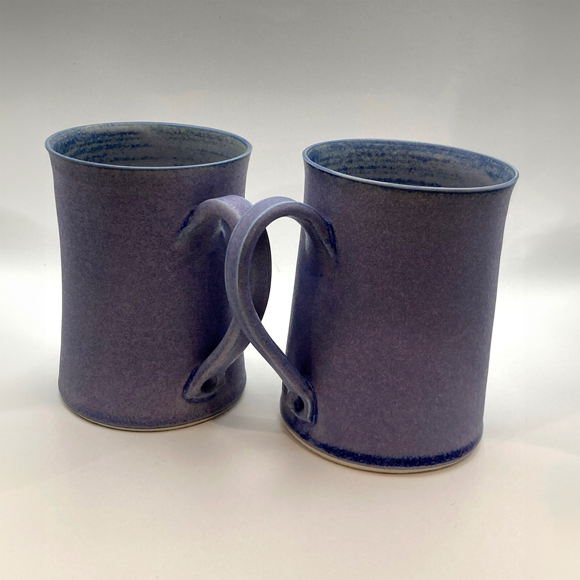 Handmade violet porcelain mug pair with cobalt blue glaze and pulled handles – Fields Pottery