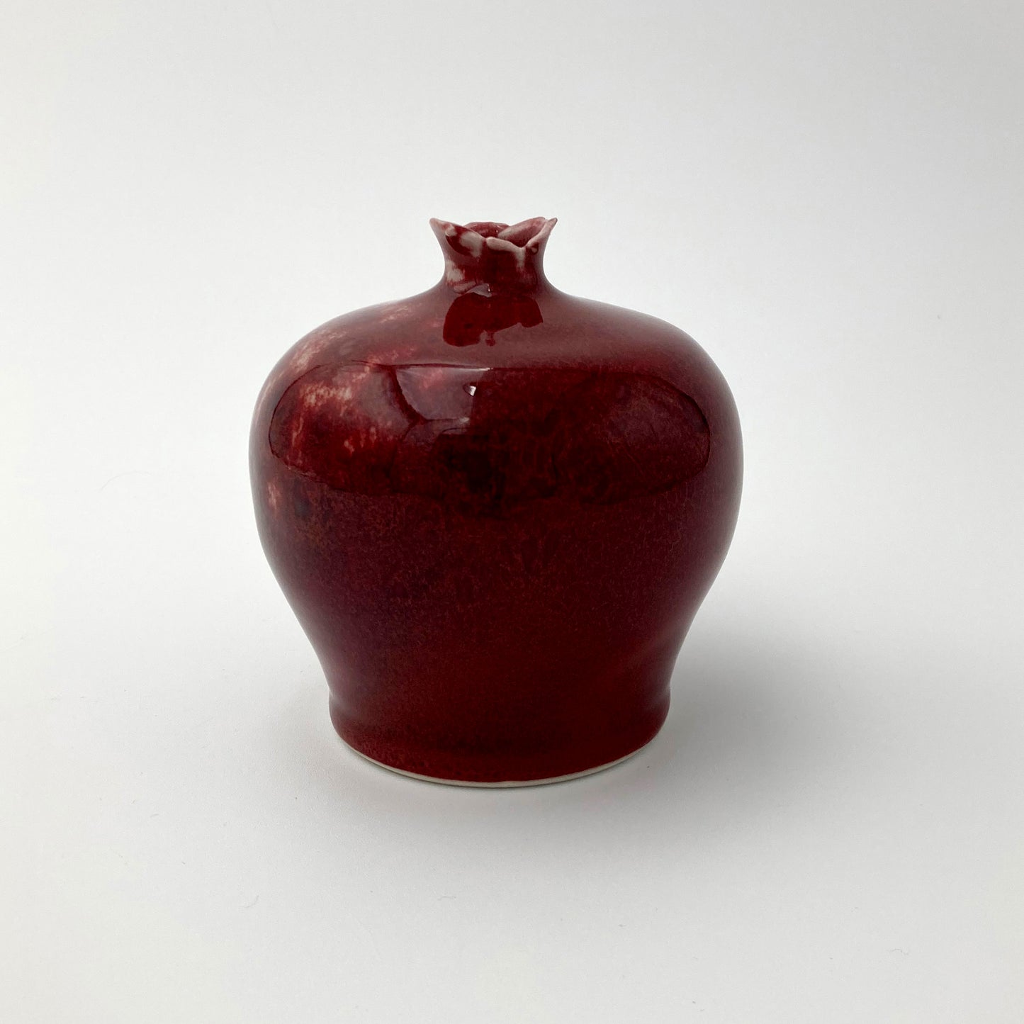 Hand thrown red glaze ceramic vase with petal rim opening, studio pottery by Fields Pottery