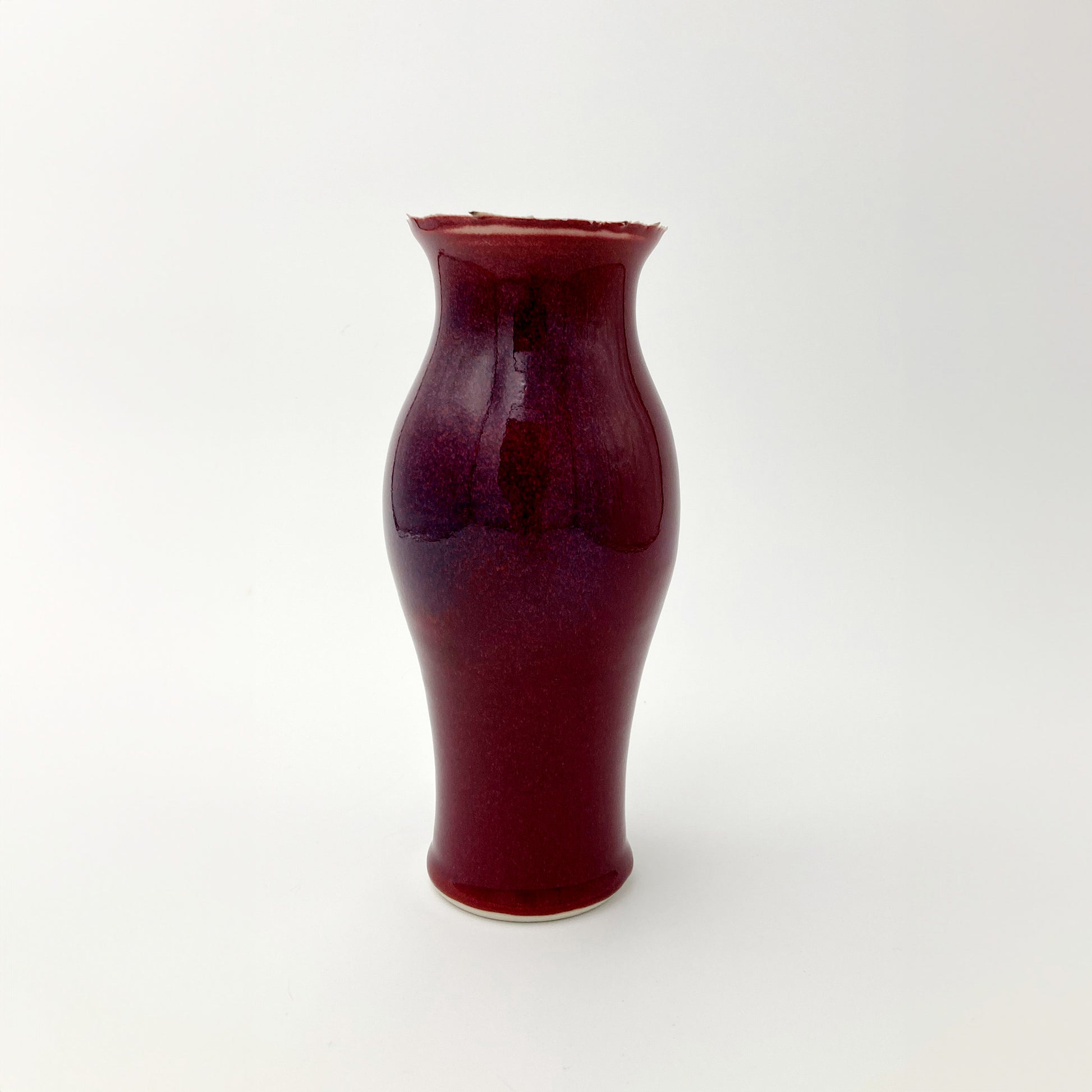 Red ceramic vase unique rim on a white background